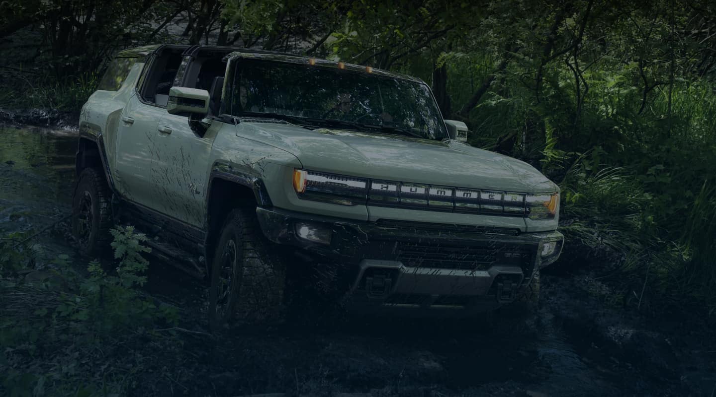 Hummer EV SUV off-roading in stream